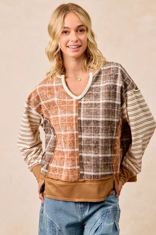 Patchwork long-sleeve top with rust and dark plaid front, striped sleeves, V-neck trim