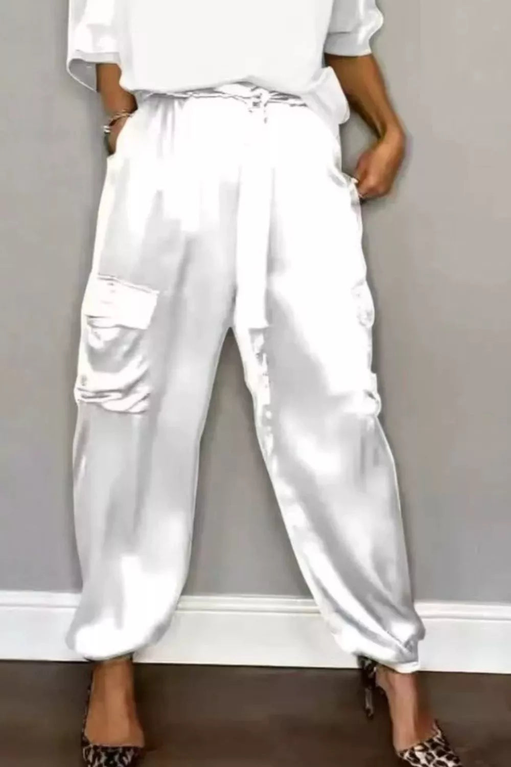 White satin cargo pants with matching round-neck top, drawstring waist, ankle cuffs
