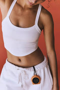 White scoop-neck active tank with ribbed knit and fitted cropped cut.