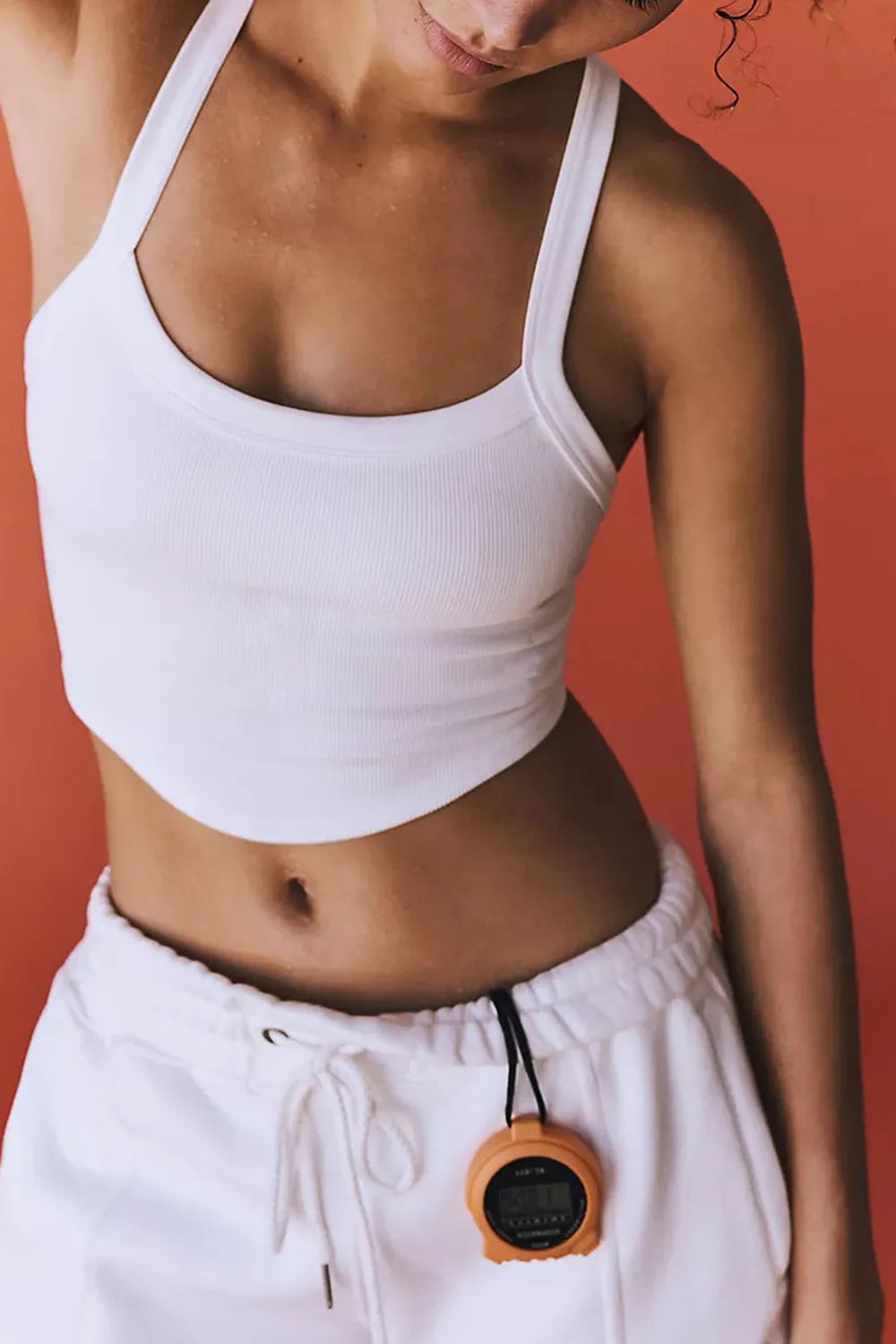 White scoop-neck active tank with ribbed knit and fitted cropped cut.