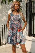 Printed sleeveless round-neck dress in blue, white, and red with circular motifs