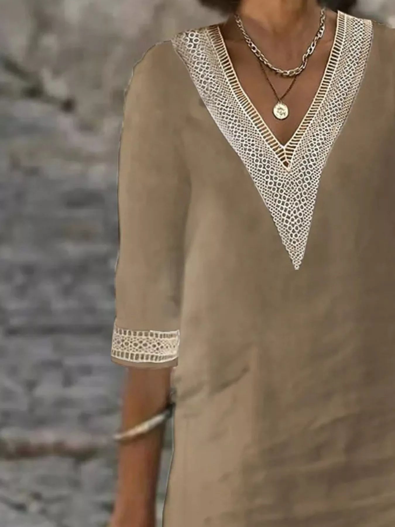 Taupe V-neck lace-trim dress detail featuring crocheted lace neckline and half sleeves