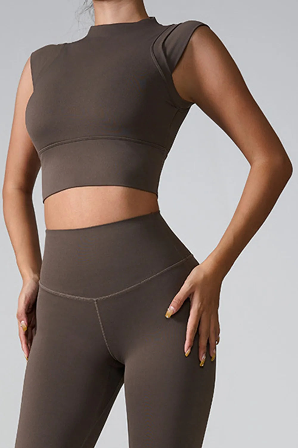 Dark brown mock neck active tank, sleeveless, cropped fitted front view.