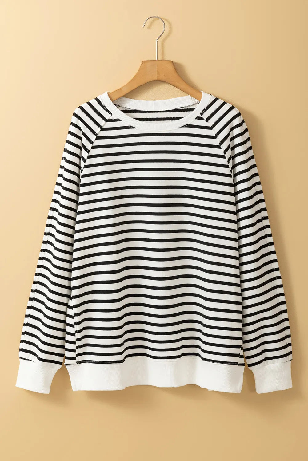 Black-and-cream striped crewneck sweatshirt with long sleeves and ribbed cuffs