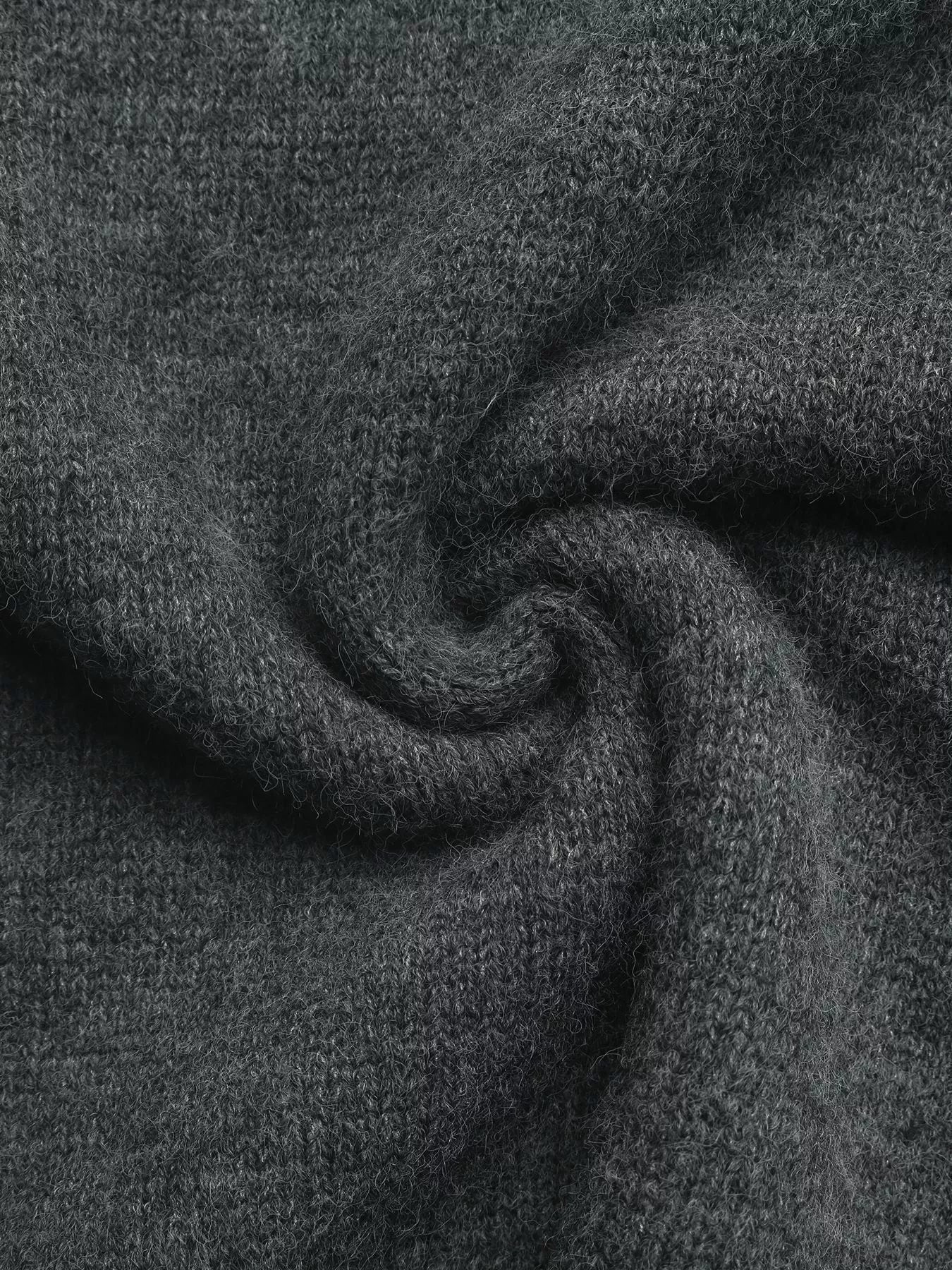 Dark gray knit fabric of a hooded quarter-zip sweater, close-up texture