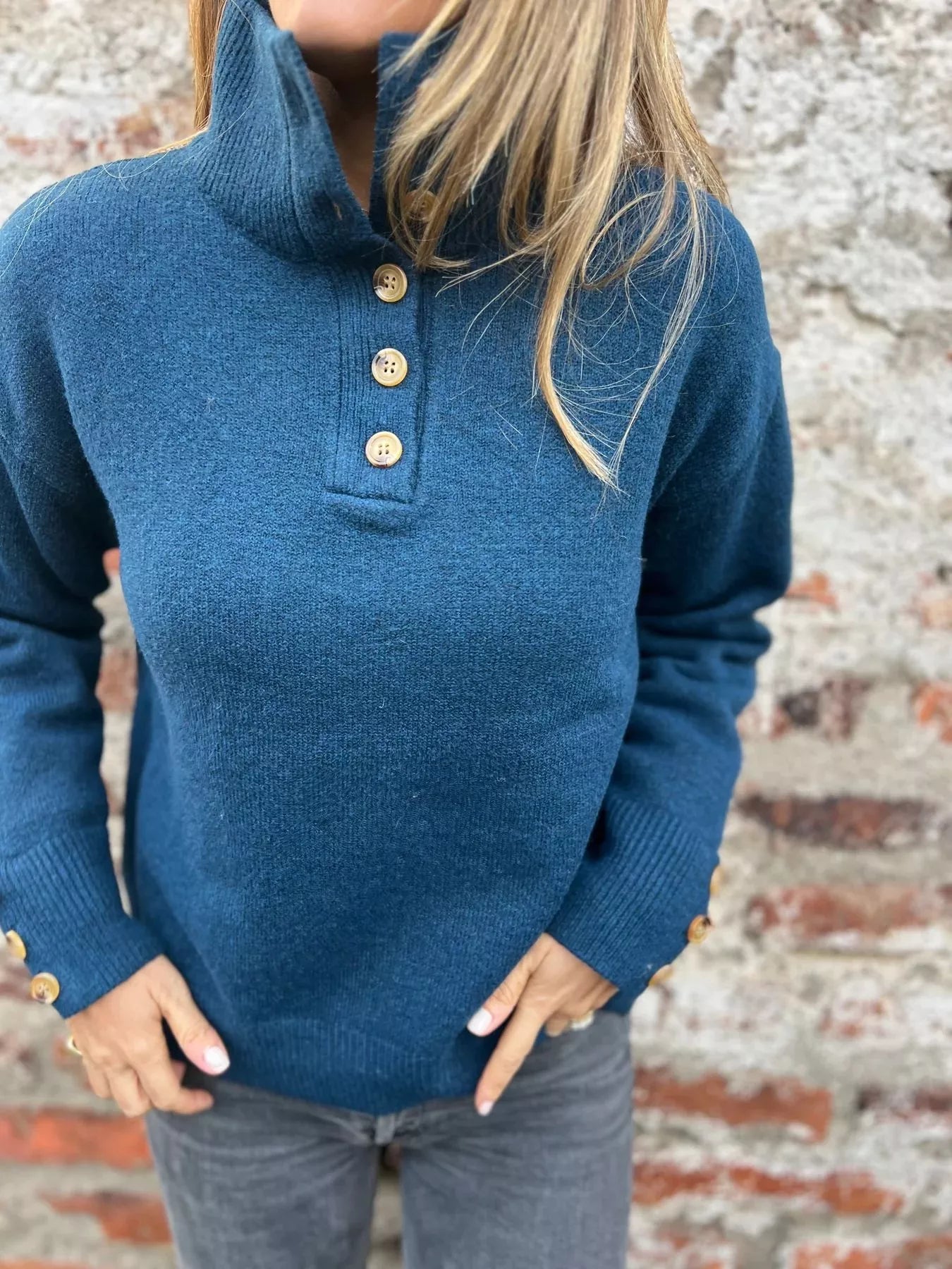 Blue turtleneck sweater with button placket and ribbed cuffs