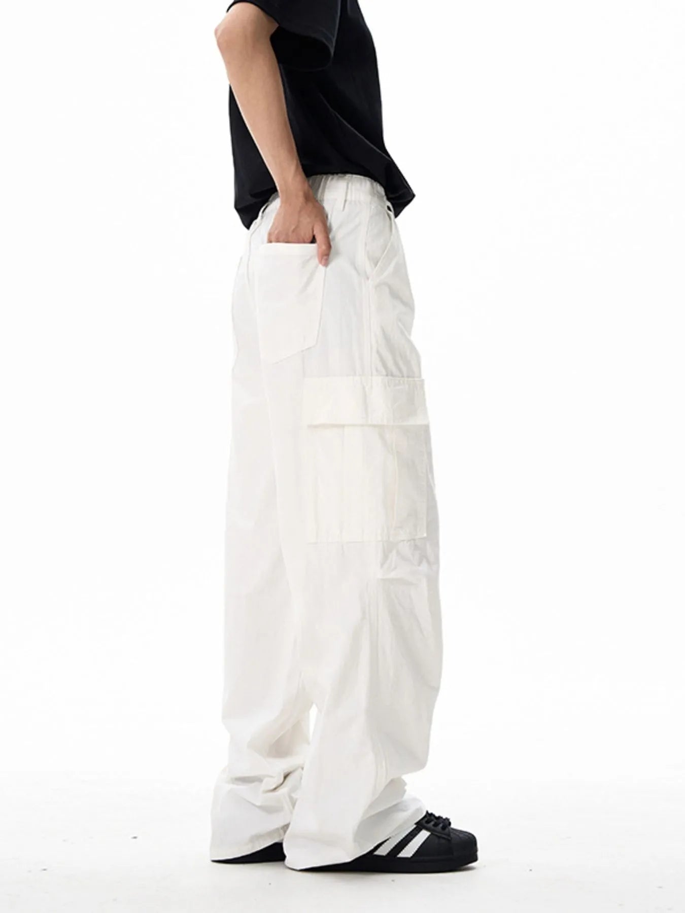 White wide-leg cargo pants with stacked cargo pocket panels and elastic waist
