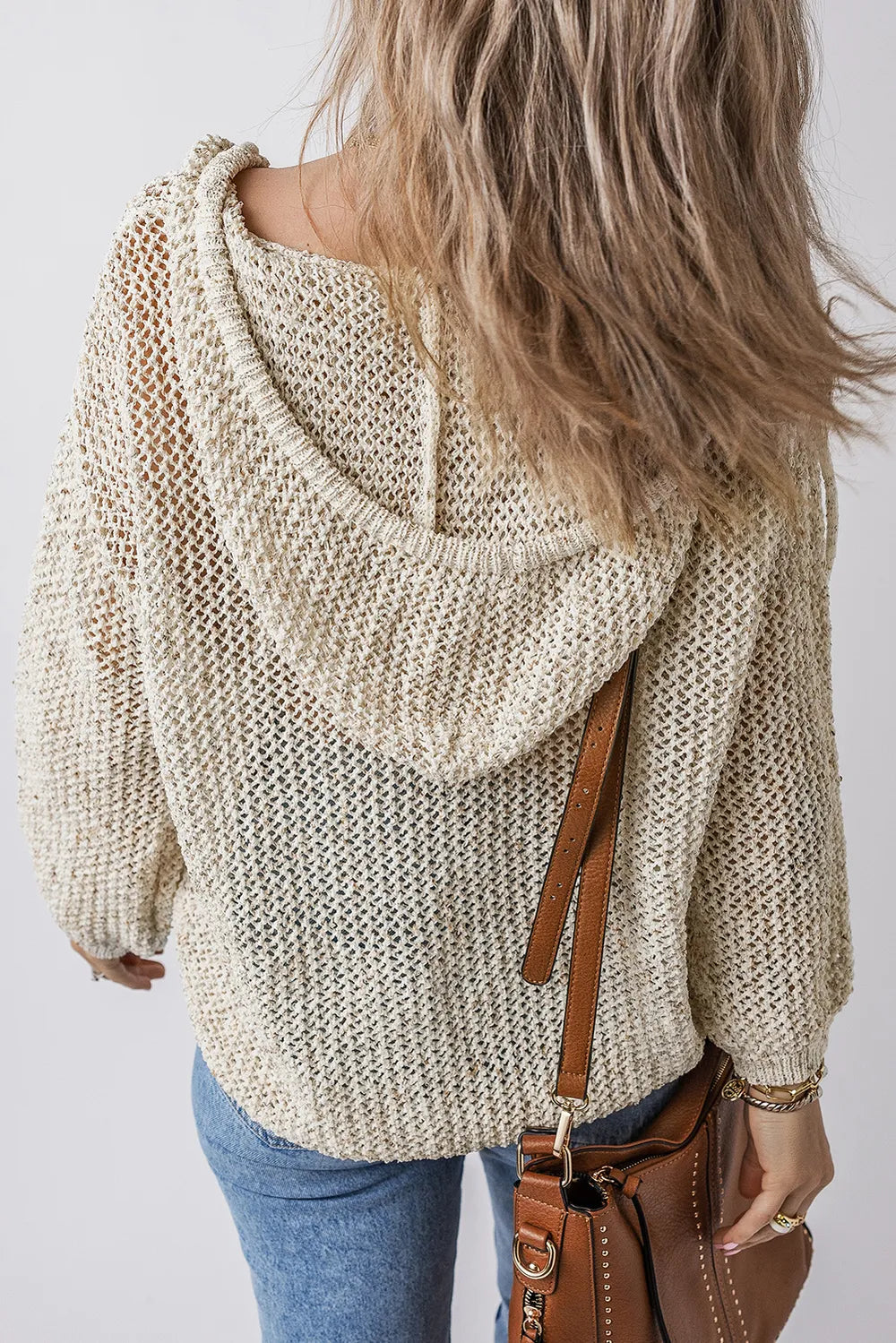 Beige openwork knit hooded top with draped hood, dropped shoulders, and back view