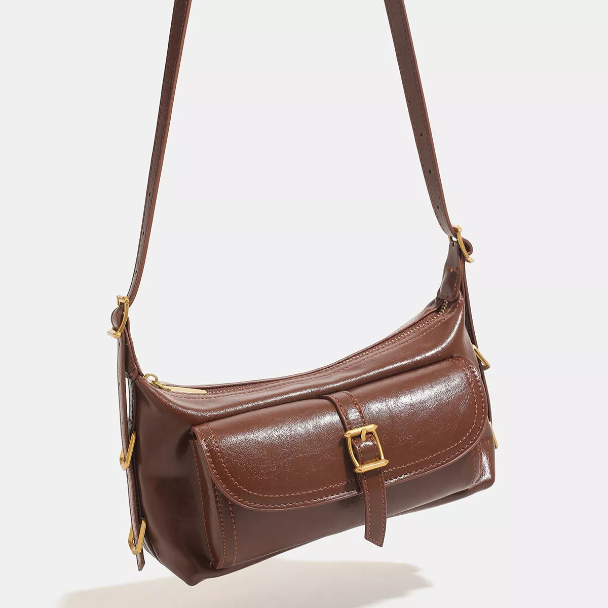 Caramel vegan leather shoulder bag with curved flap buckle detail and shoulder strap