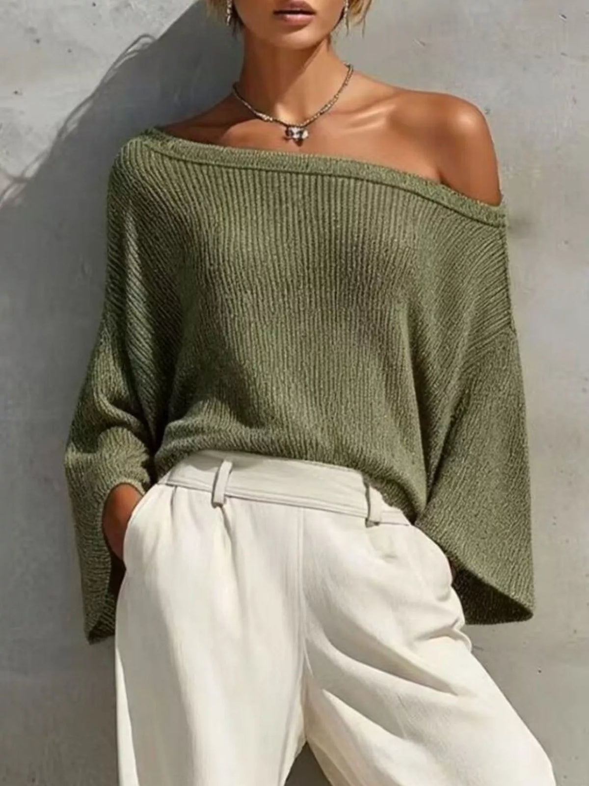 Moss green off-shoulder knit top with high-waisted white jogger pants and elastic cuffs