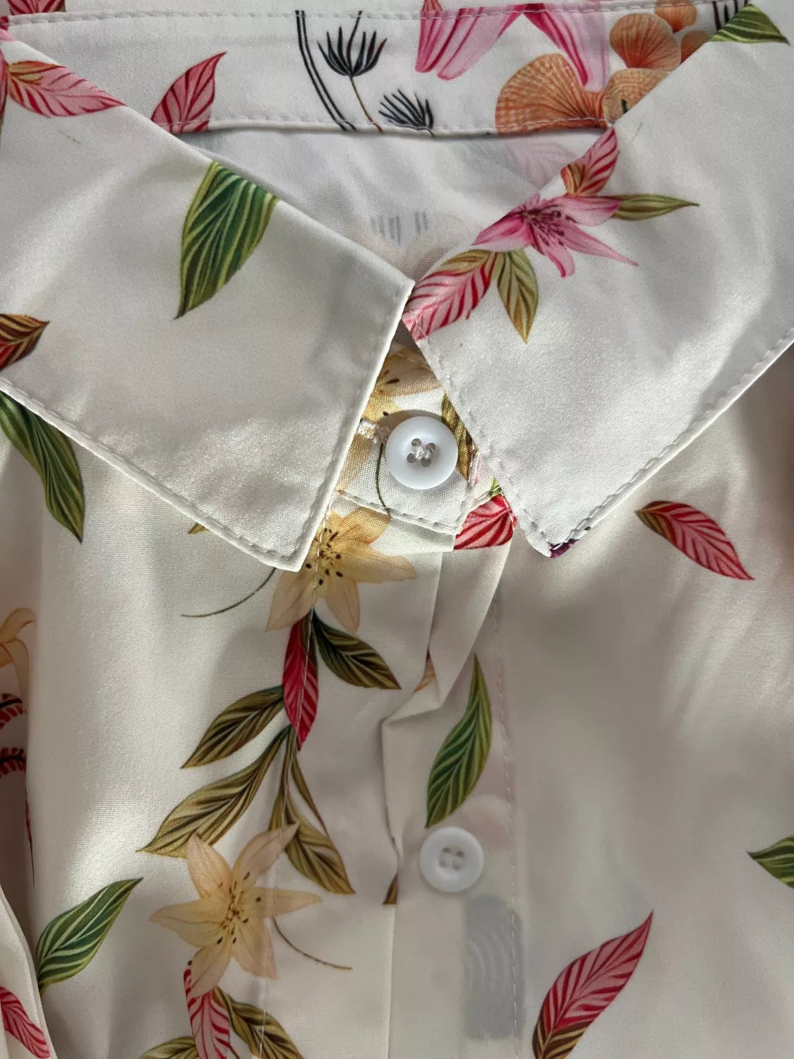 White floral romper top, V-neck with buttons and tie-waist detail