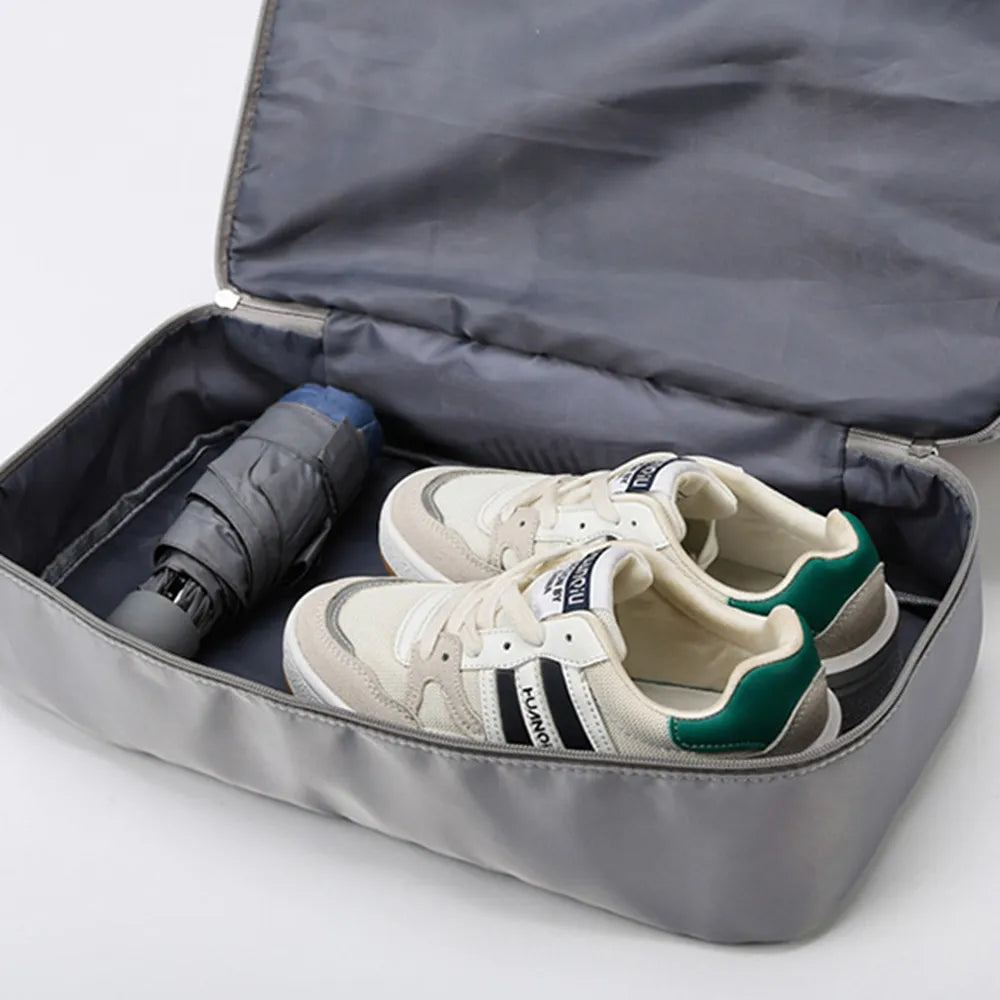 Open gray duffel bag with sneakers inside storage pocket