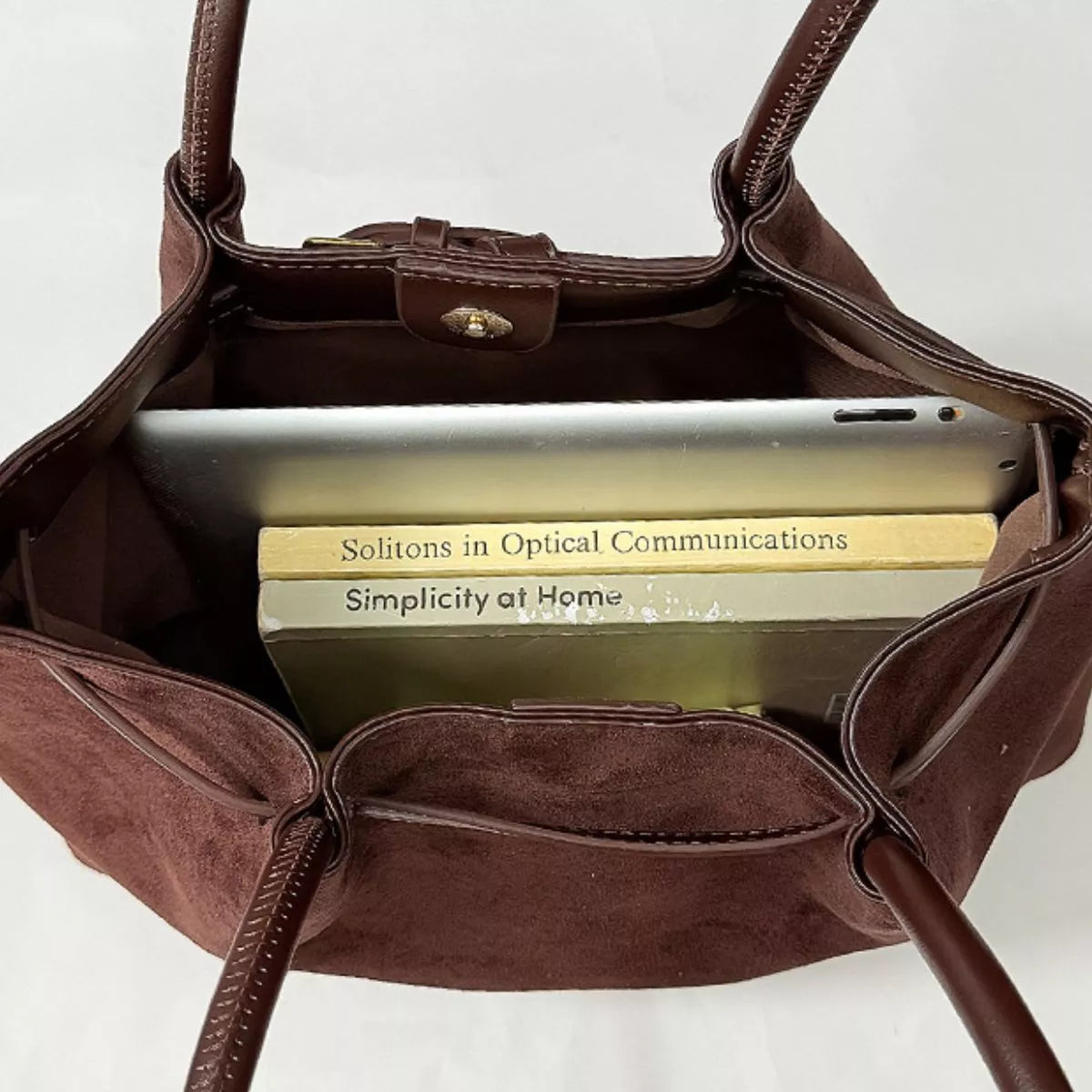 Open dark brown suede shoulder bag interior with zip top and slip pocket