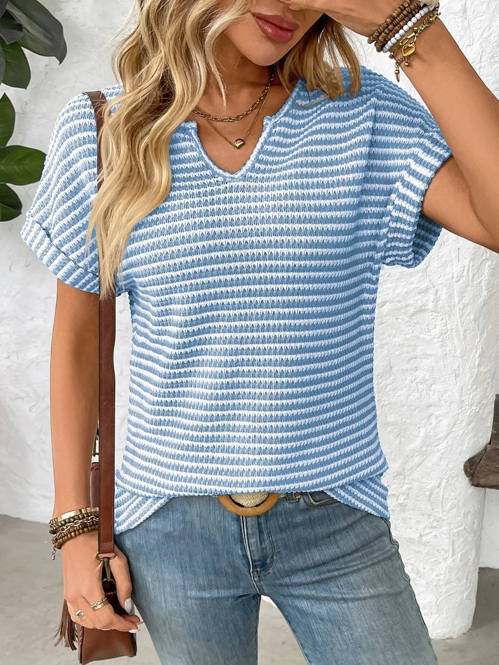 Blue and white striped short-sleeve V-neck t-shirt with ribbed texture and side slits