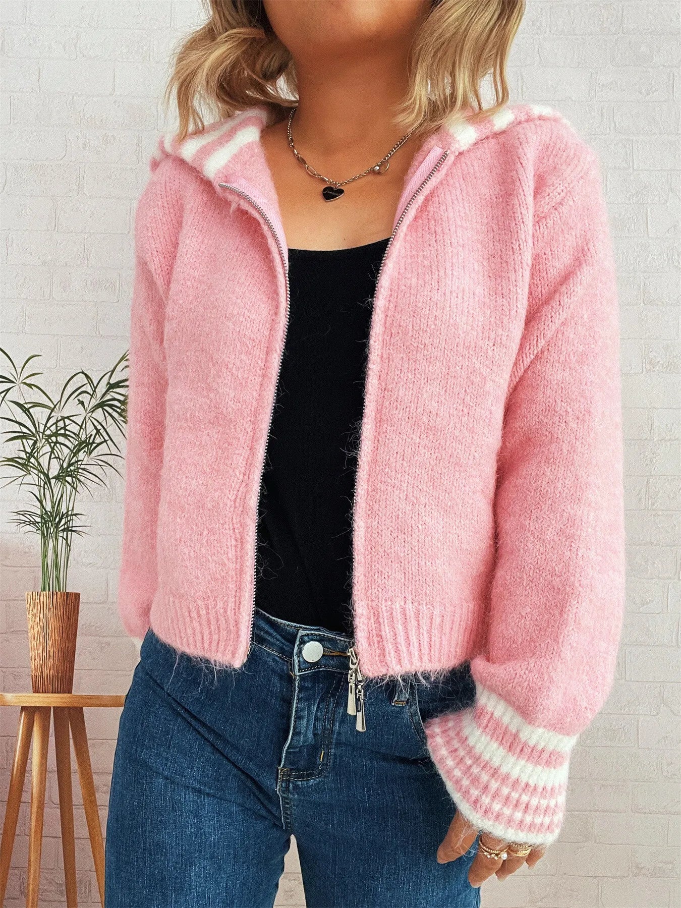 Pink zip-up cardigan with striped cuffs and ribbed collar trim
