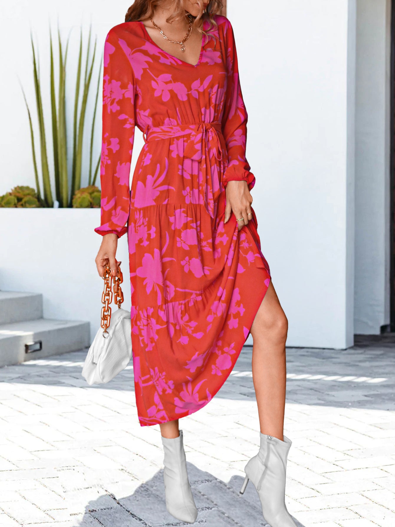 Hot pink floral V-neck long sleeve dress with cinched waist and side slit, midi length