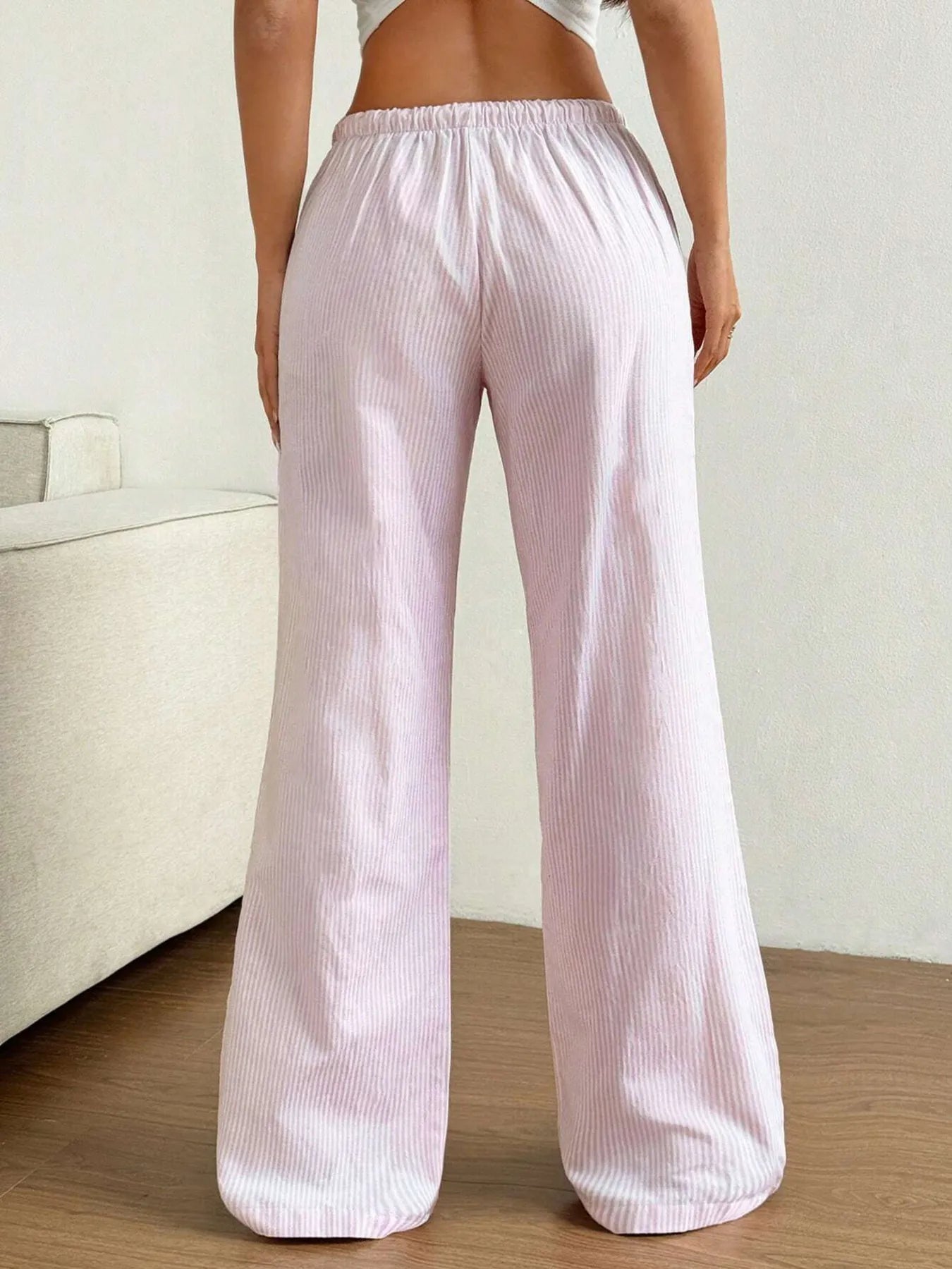 Light pink striped wide-leg pants with elastic waist and full-length relaxed legs
