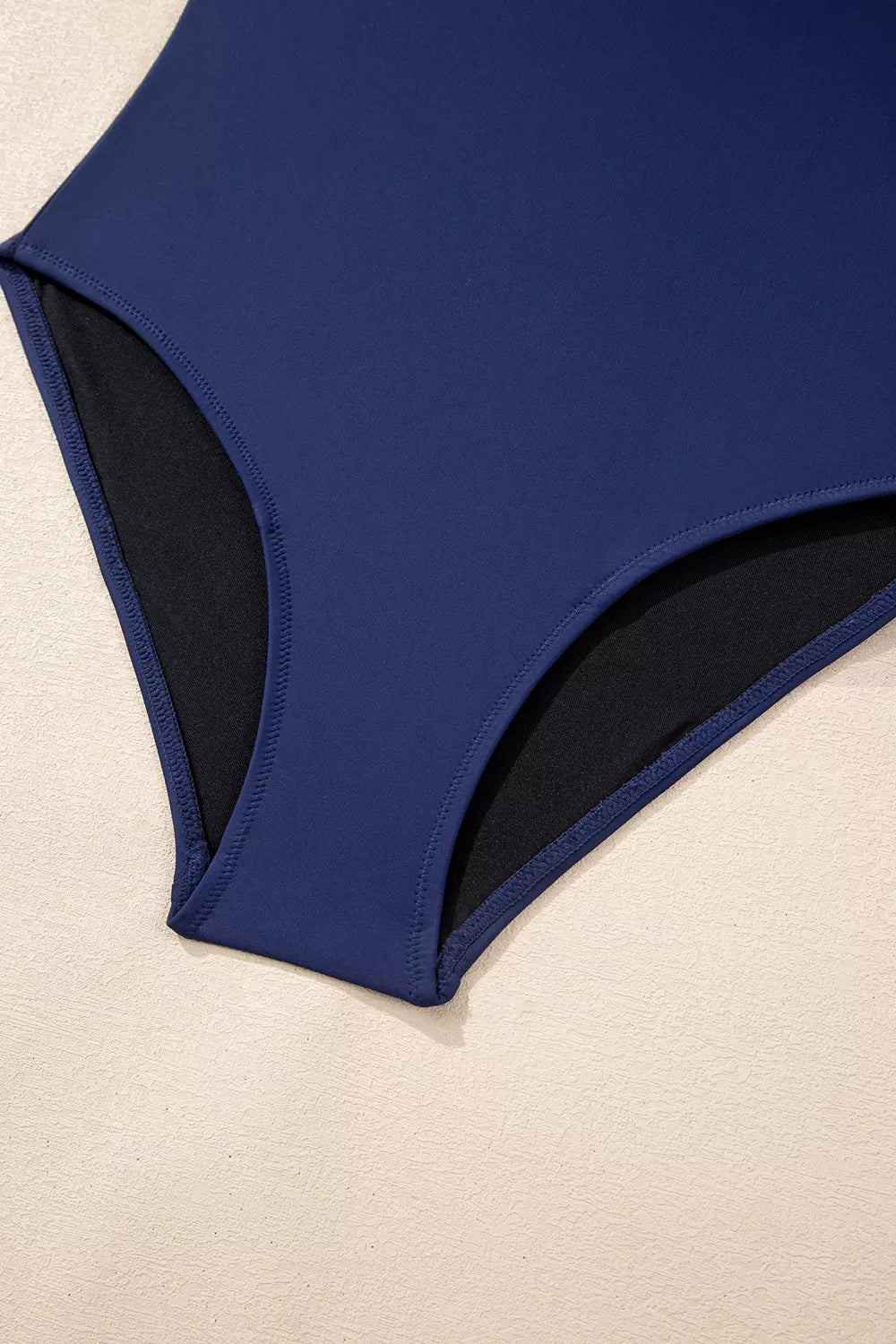 Navy high-cut swimsuit back with black side lining panels
