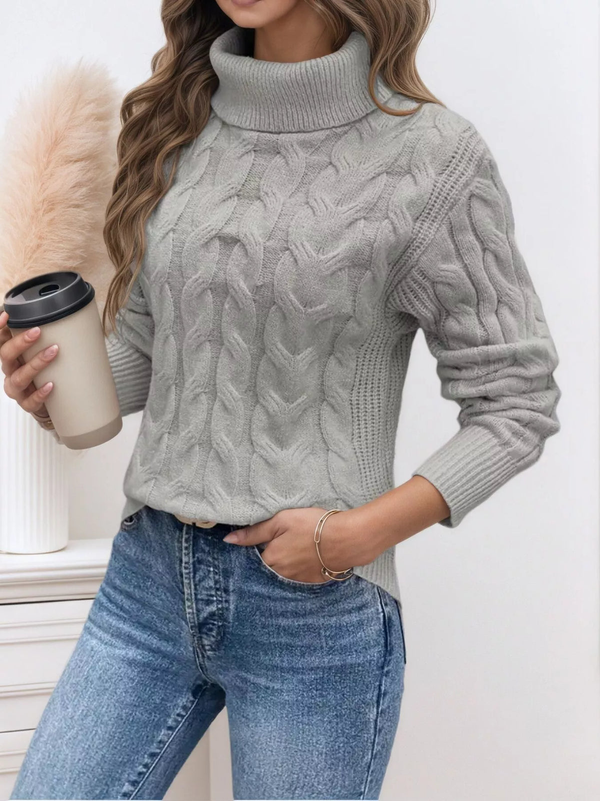 Light gray cable knit turtleneck sweater with textured cable panels and ribbed cuffs