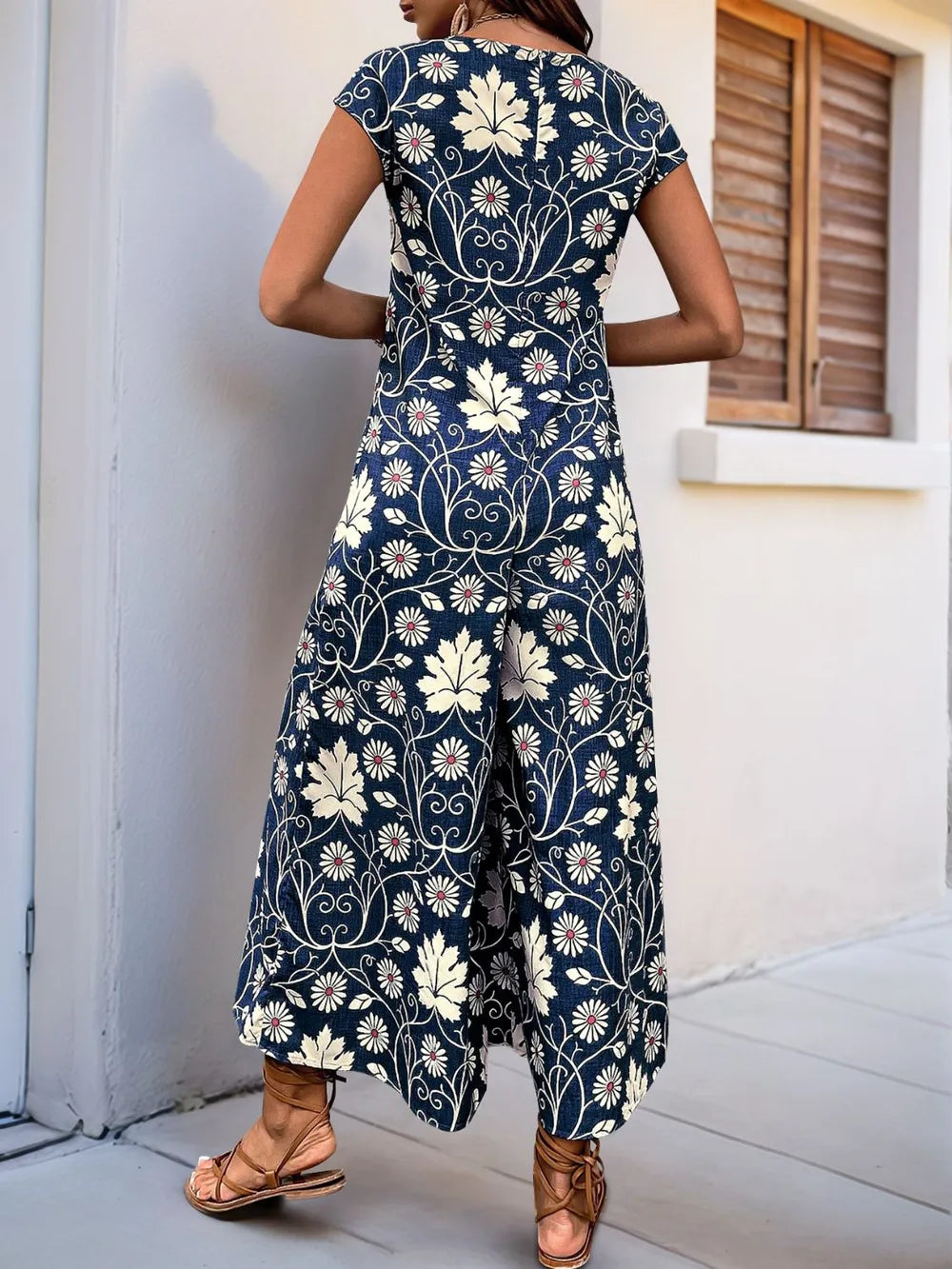 Navy printed wide-leg jumpsuit with round neck and cap sleeves, back view