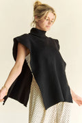 Black sleeveless knit turtleneck top with ribbed texture and side slit hem
