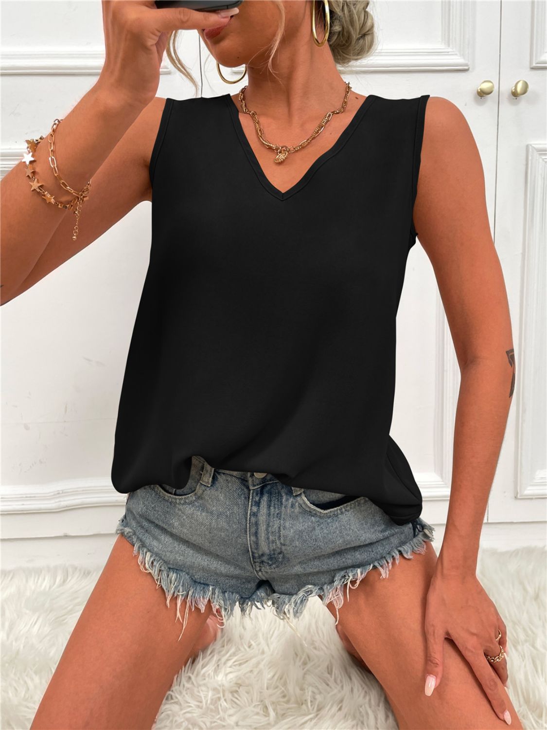 Black V-neck sleeveless tunic tank with curved hem