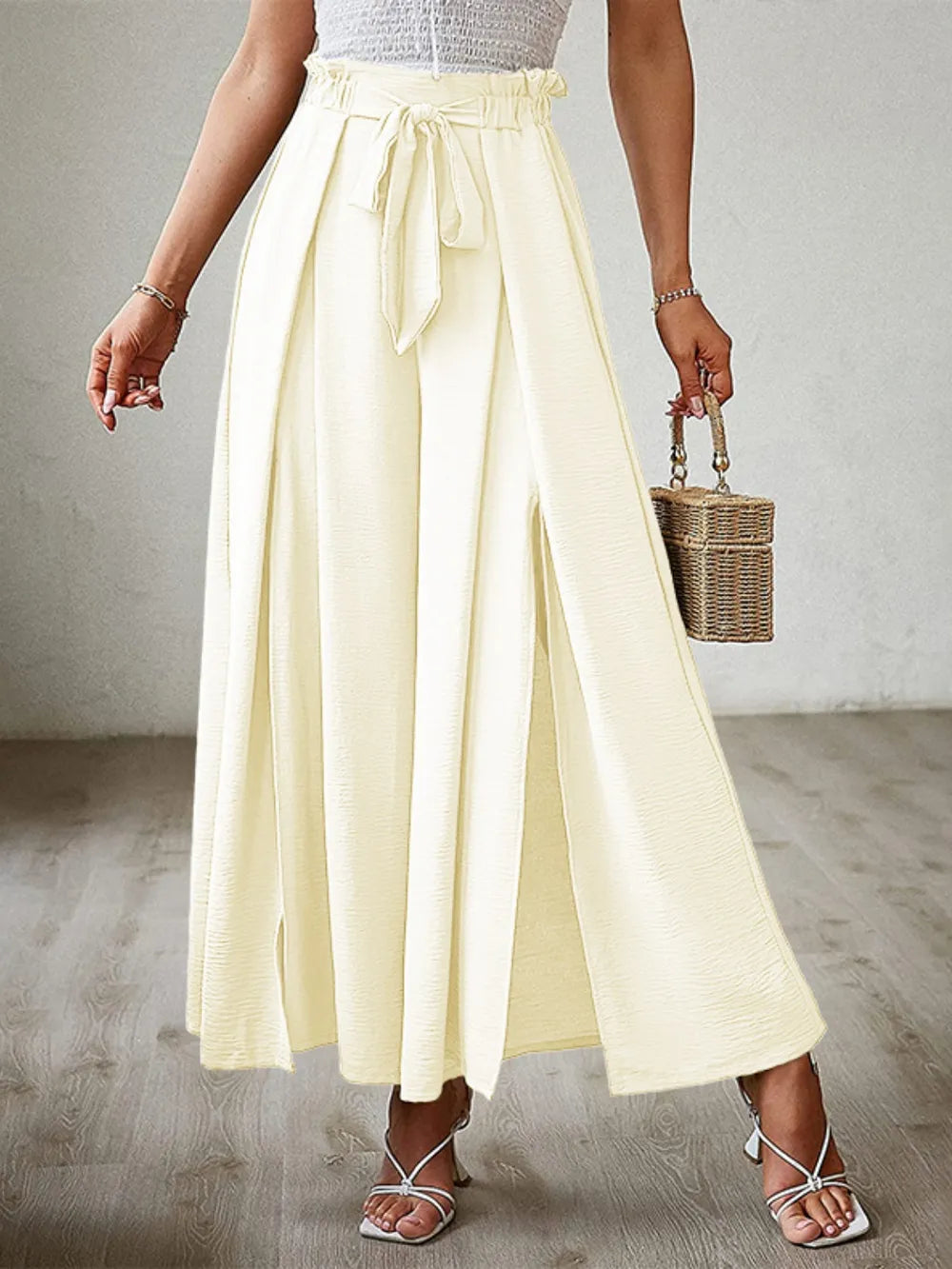 Pastel yellow tied-waist wide-leg pants with front tie and pleated wide legs