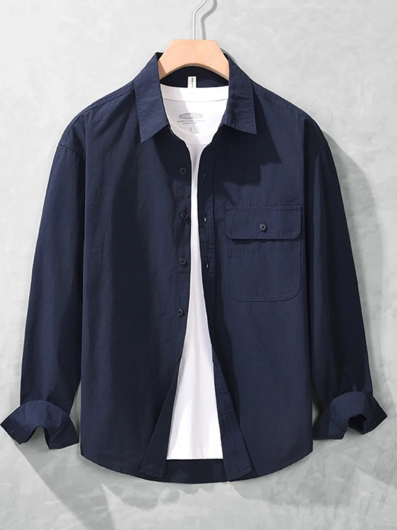 Navy button-up long sleeve shirt with chest pocket, button front, and spread collar.