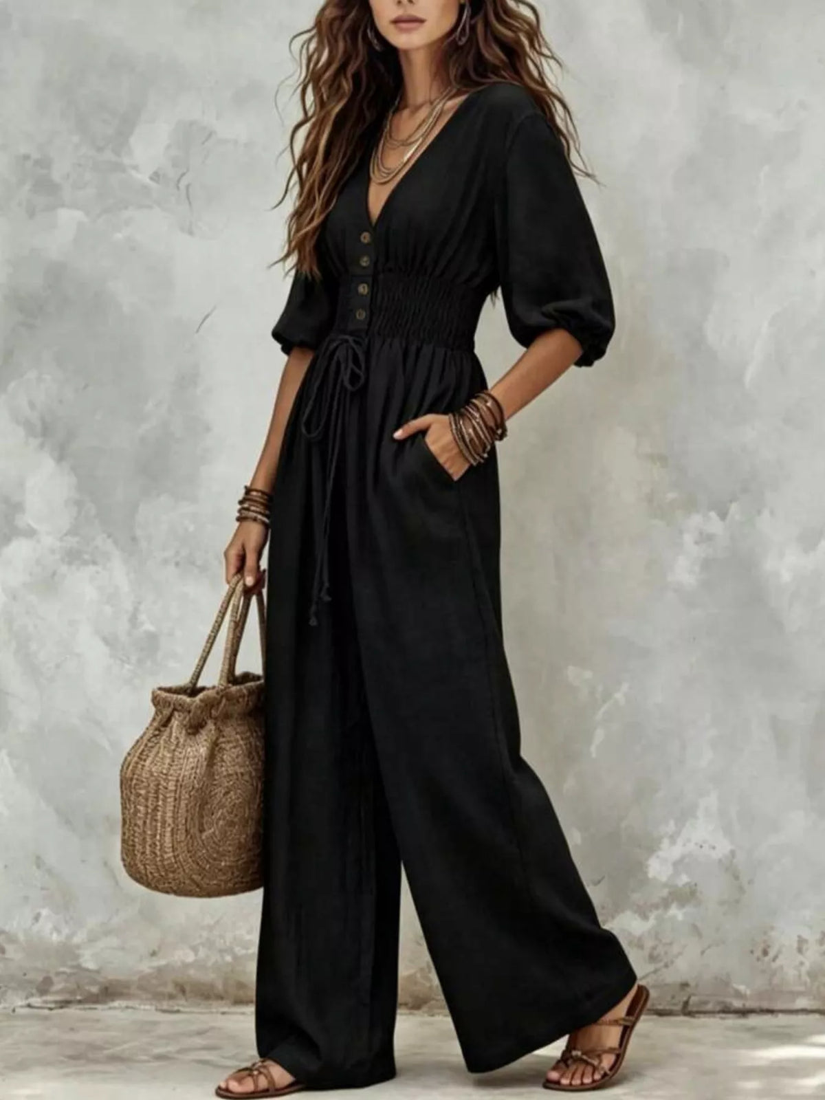 Black v-neck smocked-waist wide-leg jumpsuit with button placket