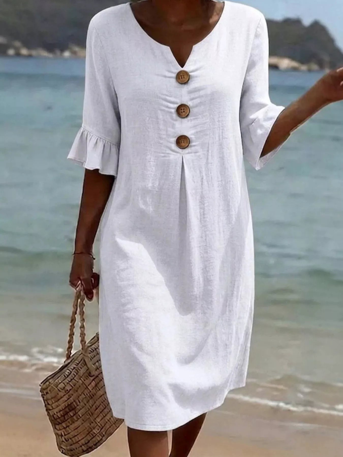 White button-front V-neck shift dress with ruffle sleeves and three wood-tone buttons