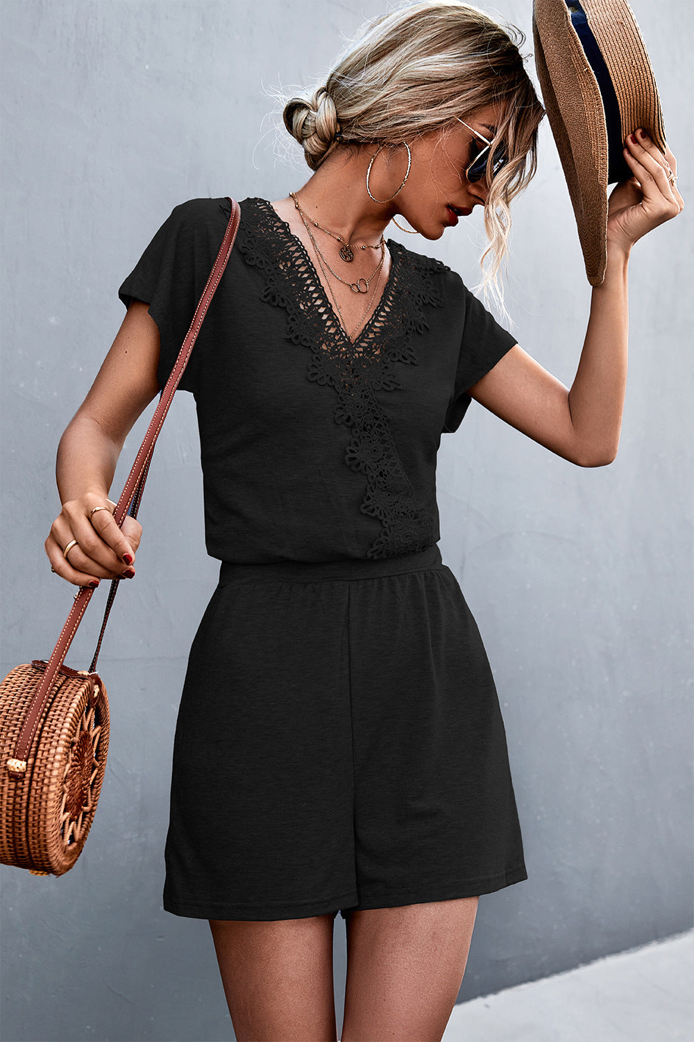 Black lace-trim V-neck romper with short sleeves and V-neck lace detail