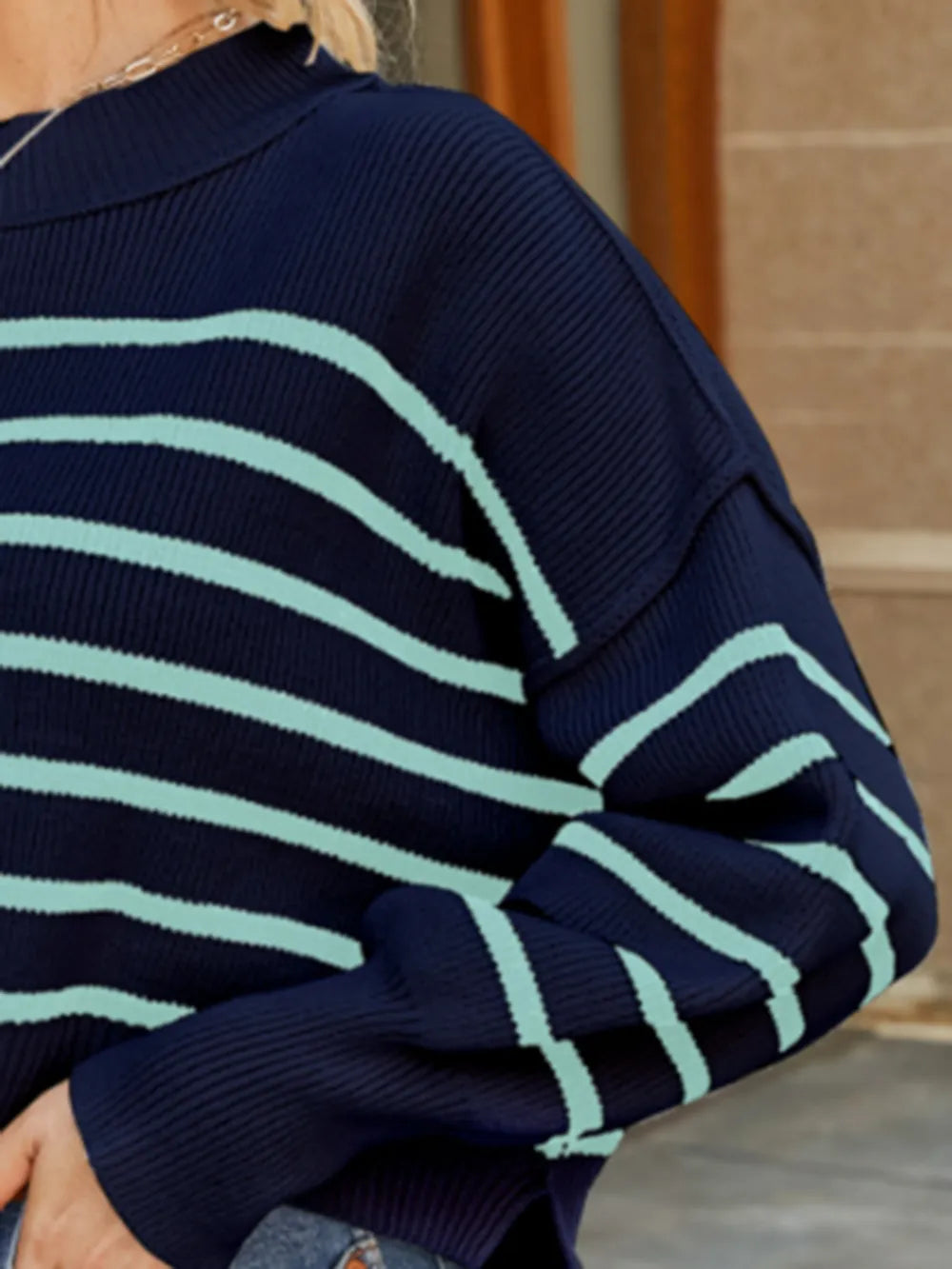 Navy striped lantern-sleeve sweater with ribbed knit cuff and sleeve texture