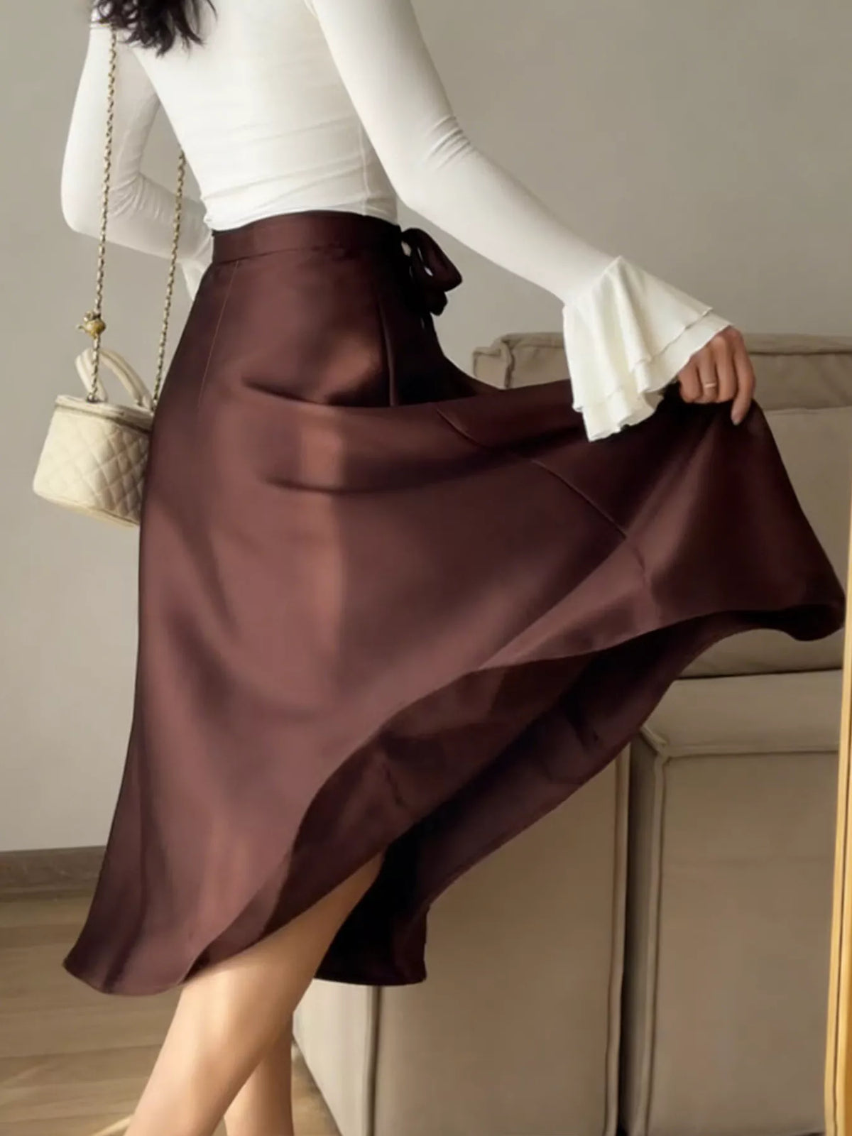 Burgundy satin A-line midi skirt with smooth drape and wrap-style front