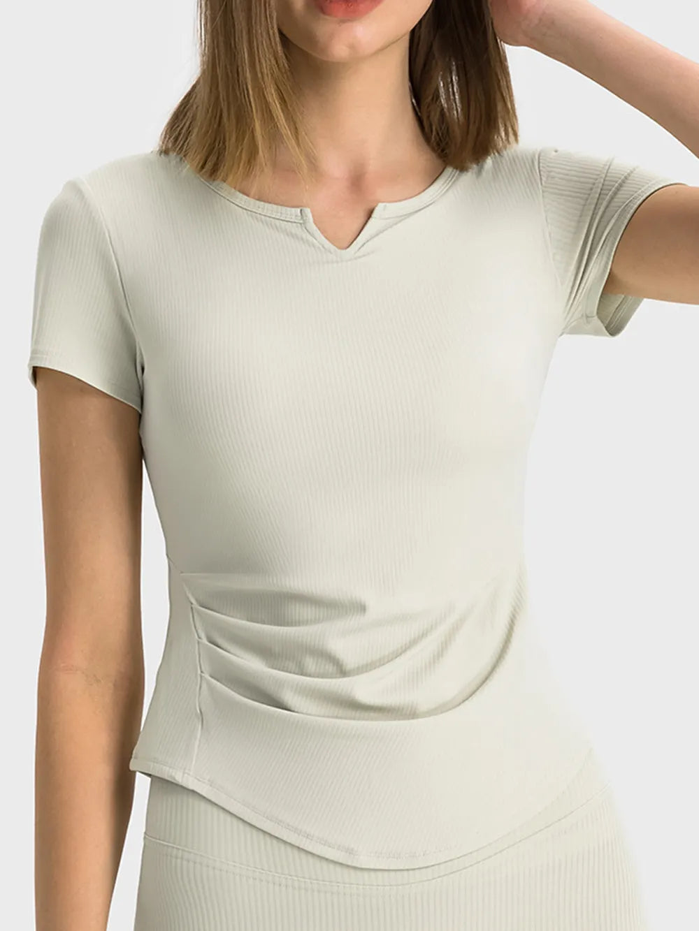 Light cream active t-shirt with notched V-neck and short sleeves