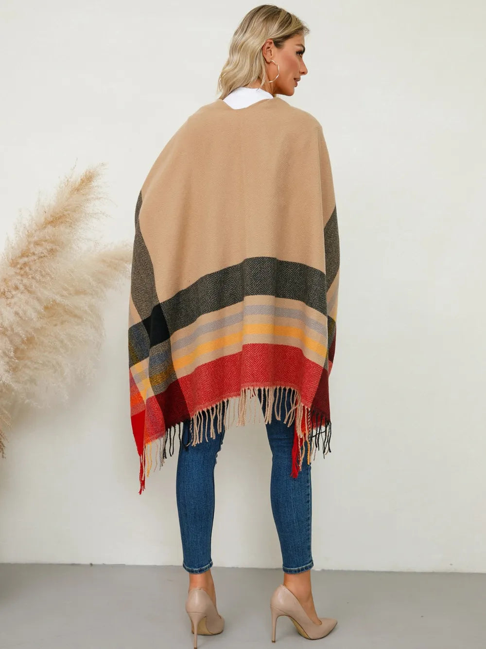 Plaid poncho with fringe trim, back view, tan with gray and red banded checks