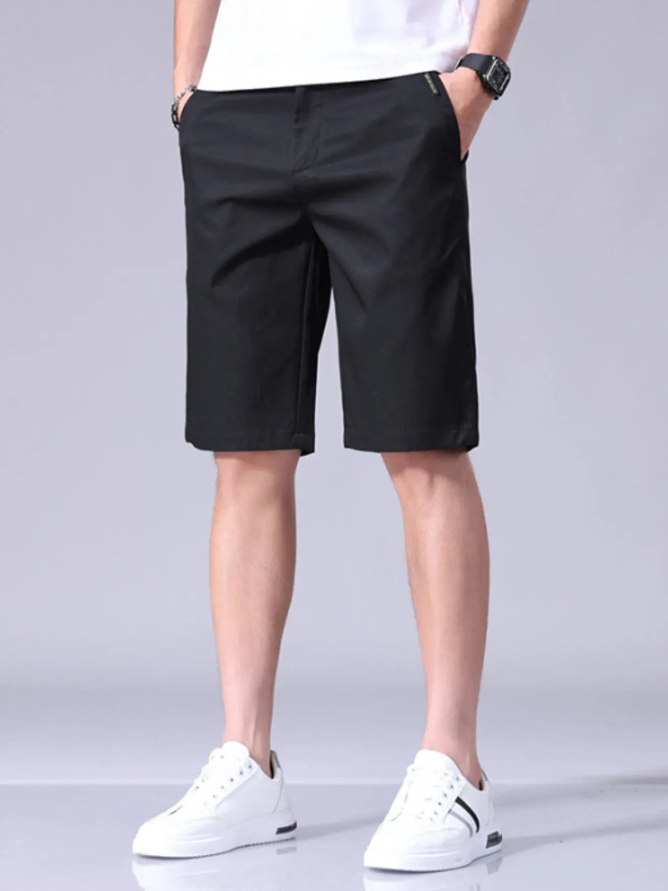 Black men's casual shorts with pockets, belt loops, and button closure
