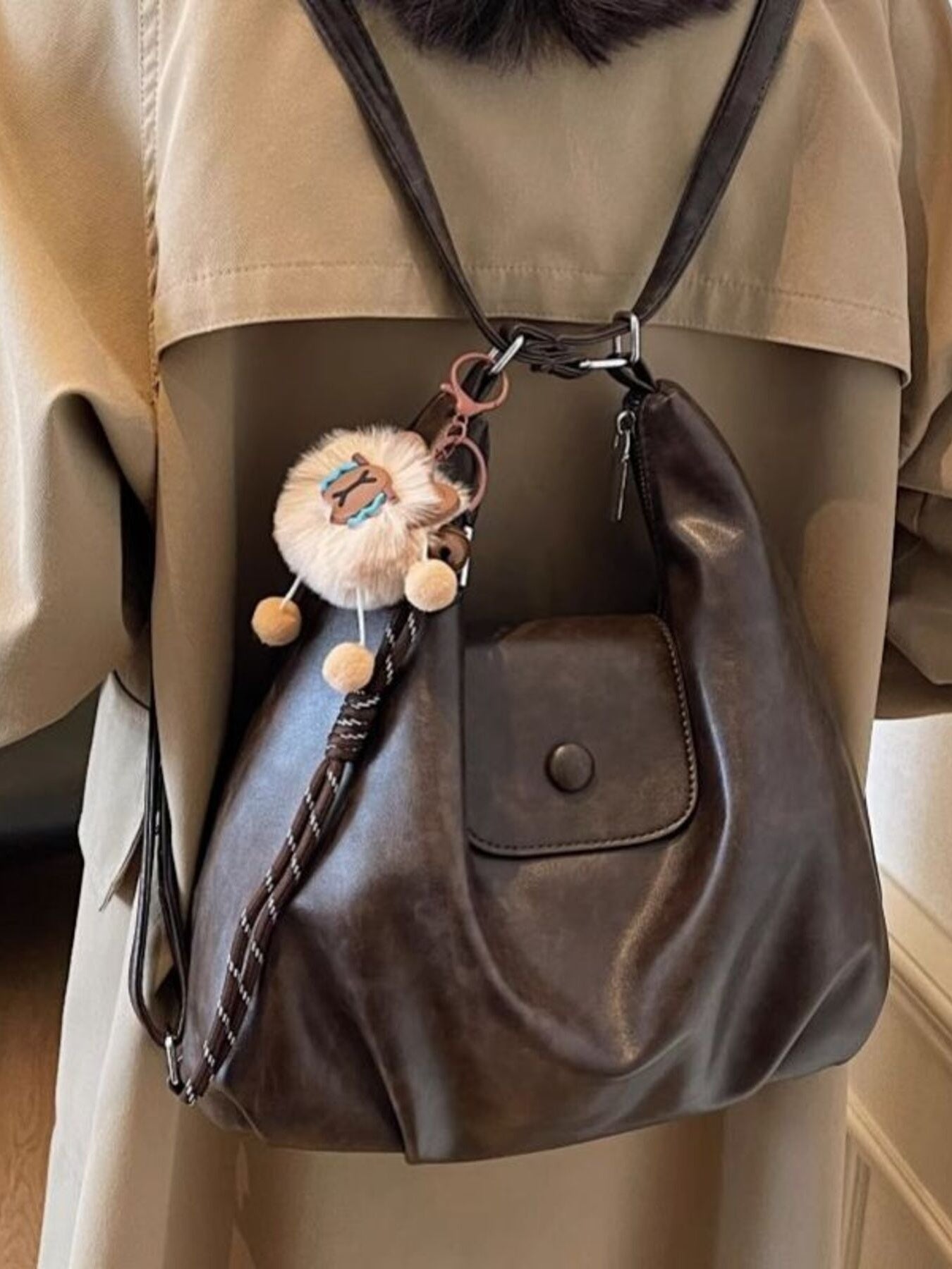 Adjustable Strap Shoulder Bag, brown PU leather with front snap pocket and decorative pom-pom keychain