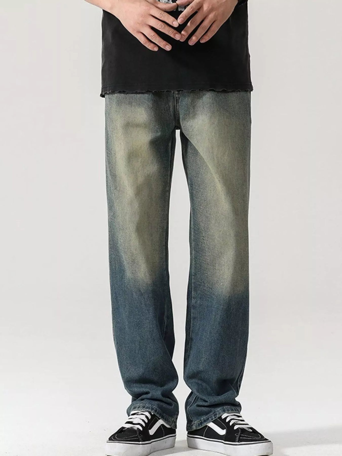 Men's washed teal denim jeans with wide-leg cut, button fly, and belt loops