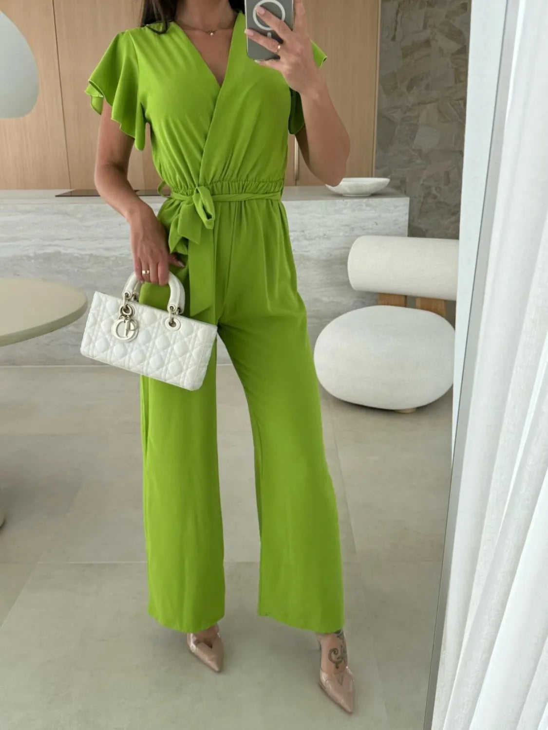 Lime green ruffle-sleeve wide-leg jumpsuit with tied waist and V-neck
