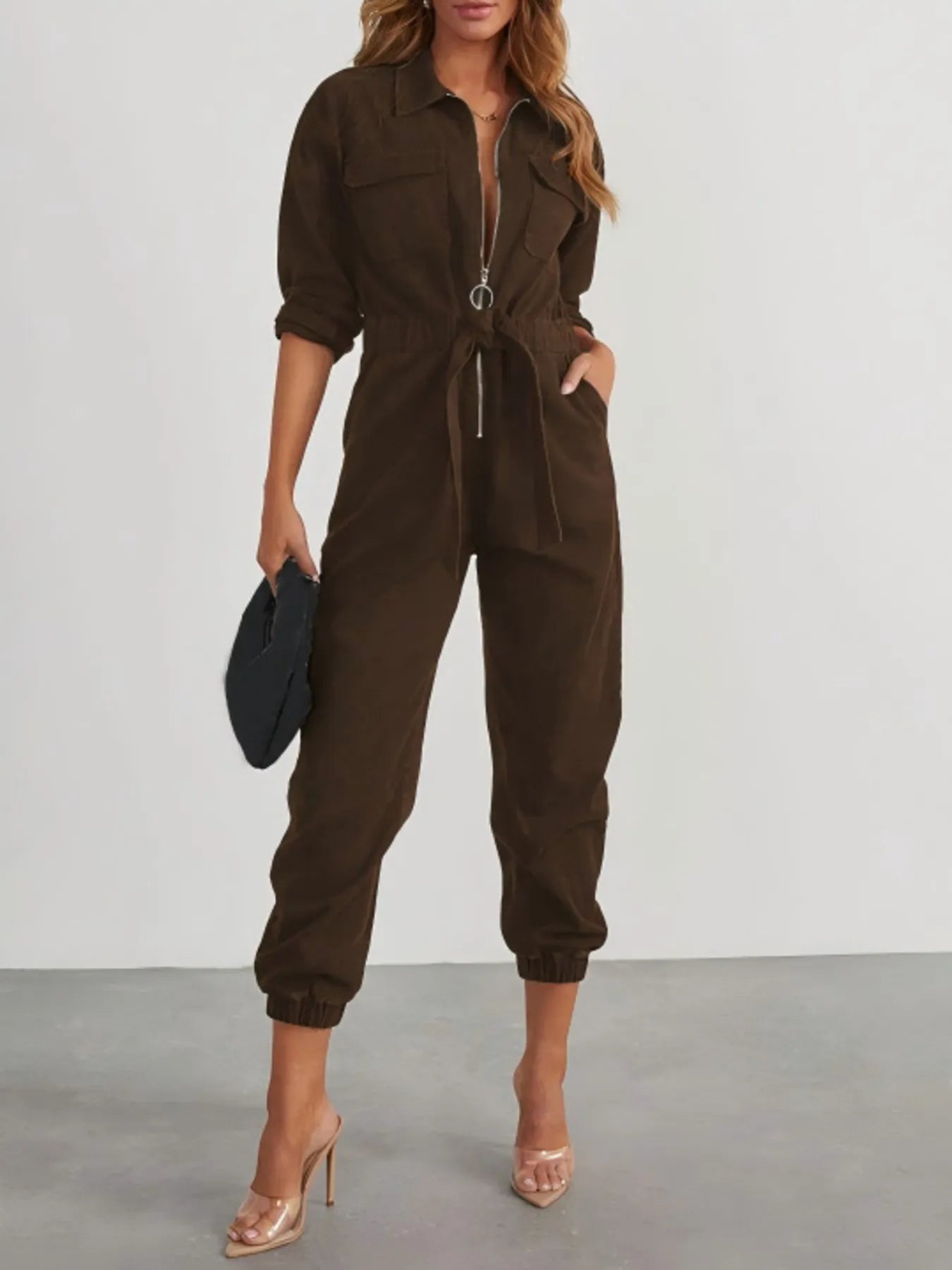 Dark brown long-sleeve zip-front jumpsuit with drawstring waist and cuffed legs