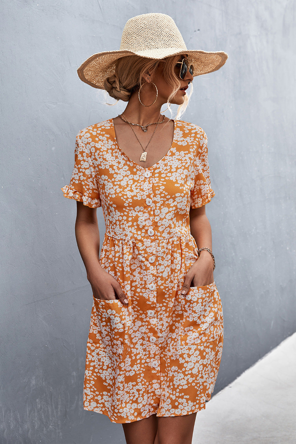 Orange floral printed button-front dress with V-neck and patch pockets, short-sleeve fit.