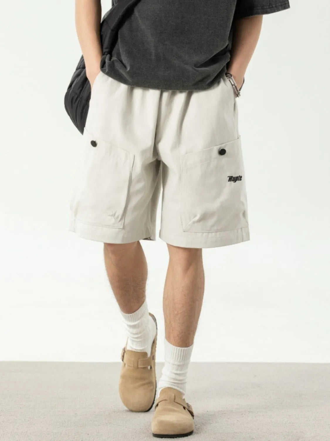 Ivory drawstring shorts with side pockets, elastic waist and button detail