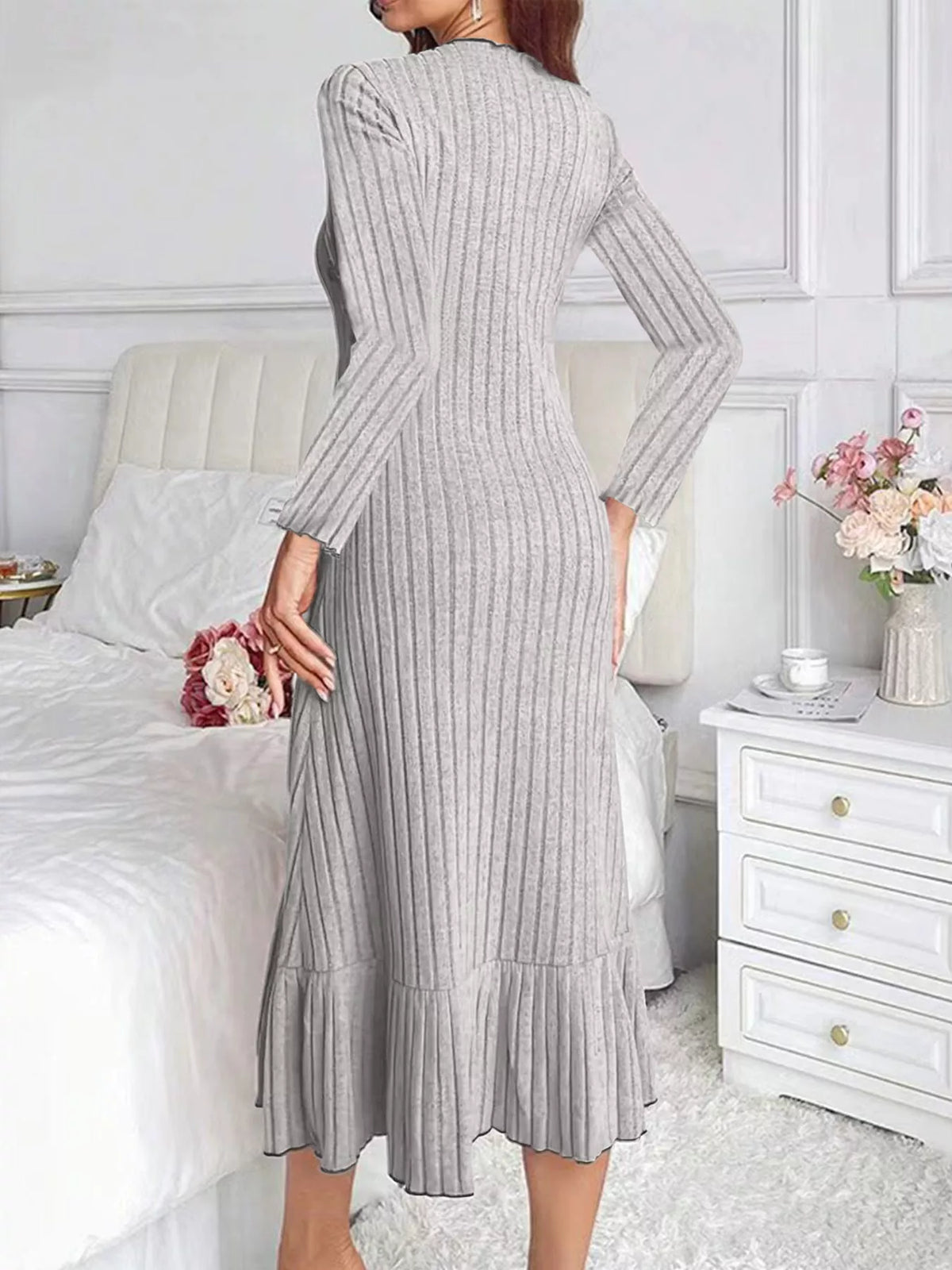 Light gray ribbed knit bodycon dress with long sleeves and ruffle hem—back view
