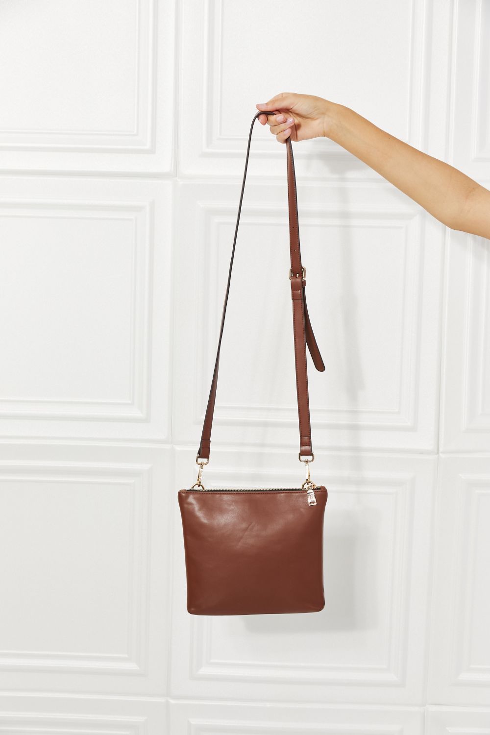 Chestnut brown solid handbag with thin shoulder straps and small gold hardware