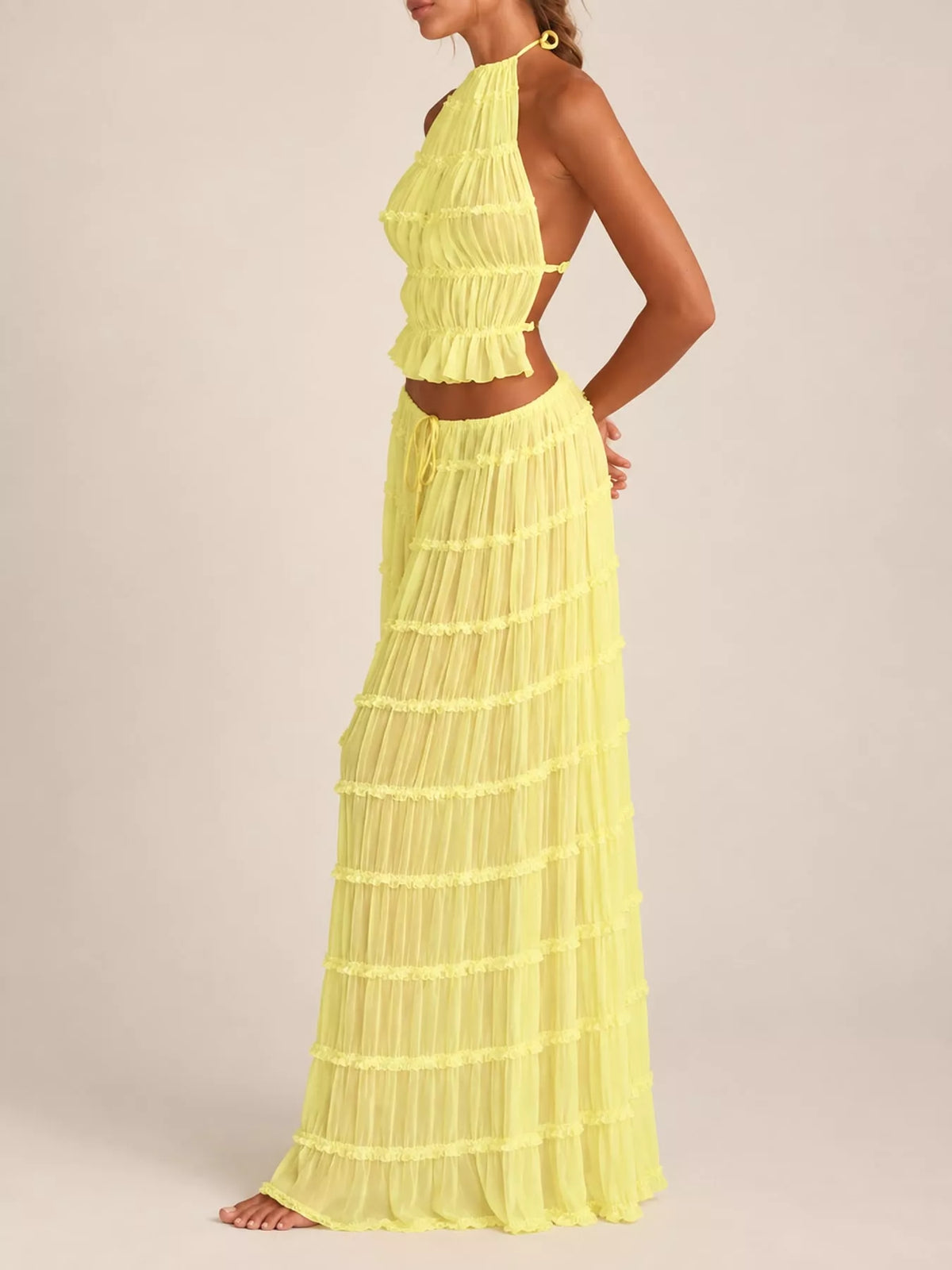 Yellow ruffled halter crop top and tiered maxi skirt set
