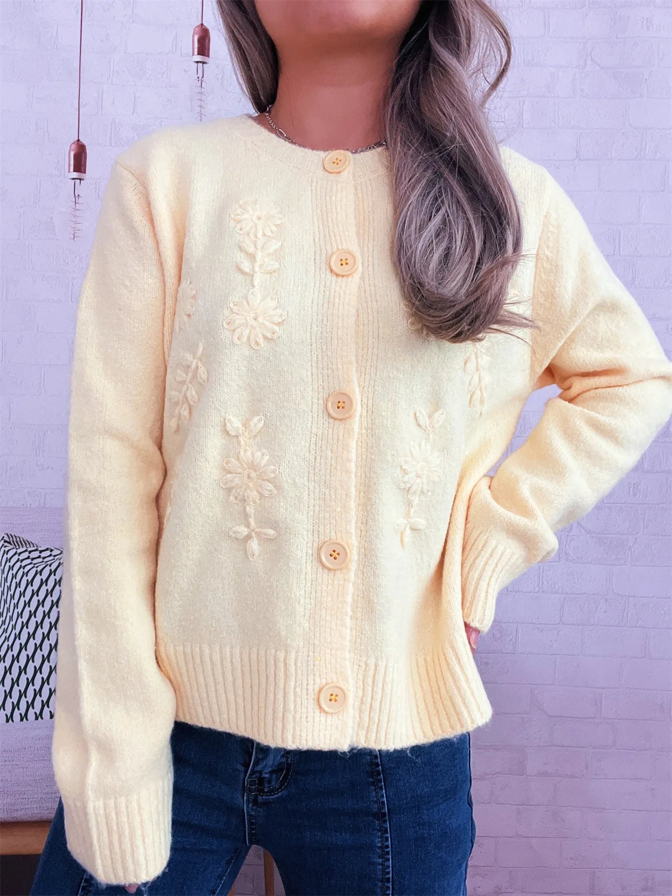Beige cardigan with long sleeves, flower embroidery, and button front