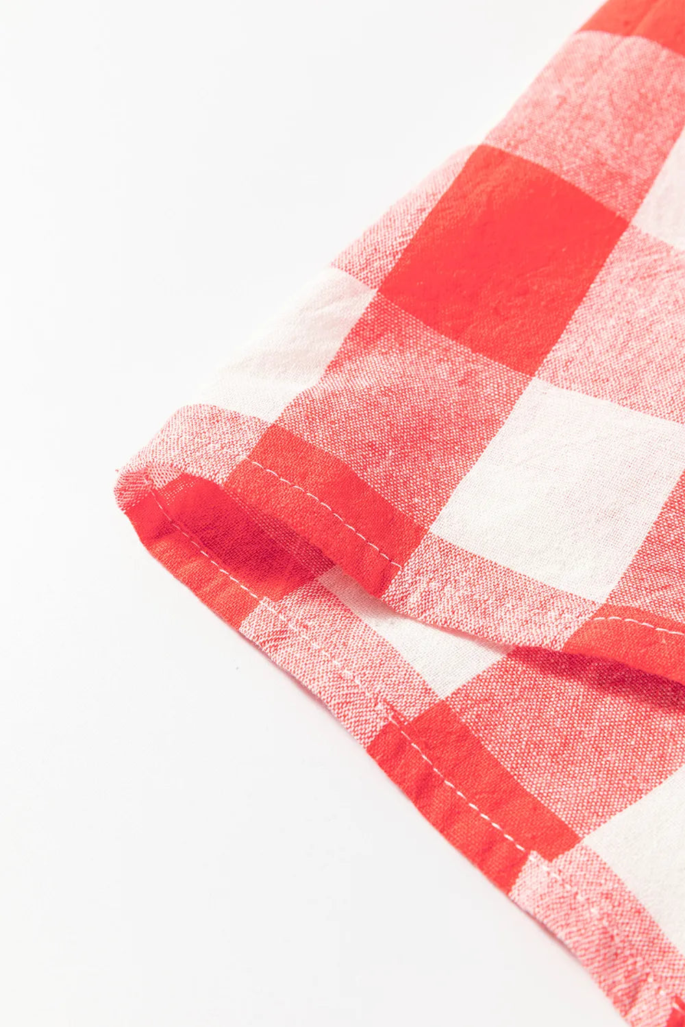 Strawberry plaid shirt dress hem with stitched edge and long sleeve cuff