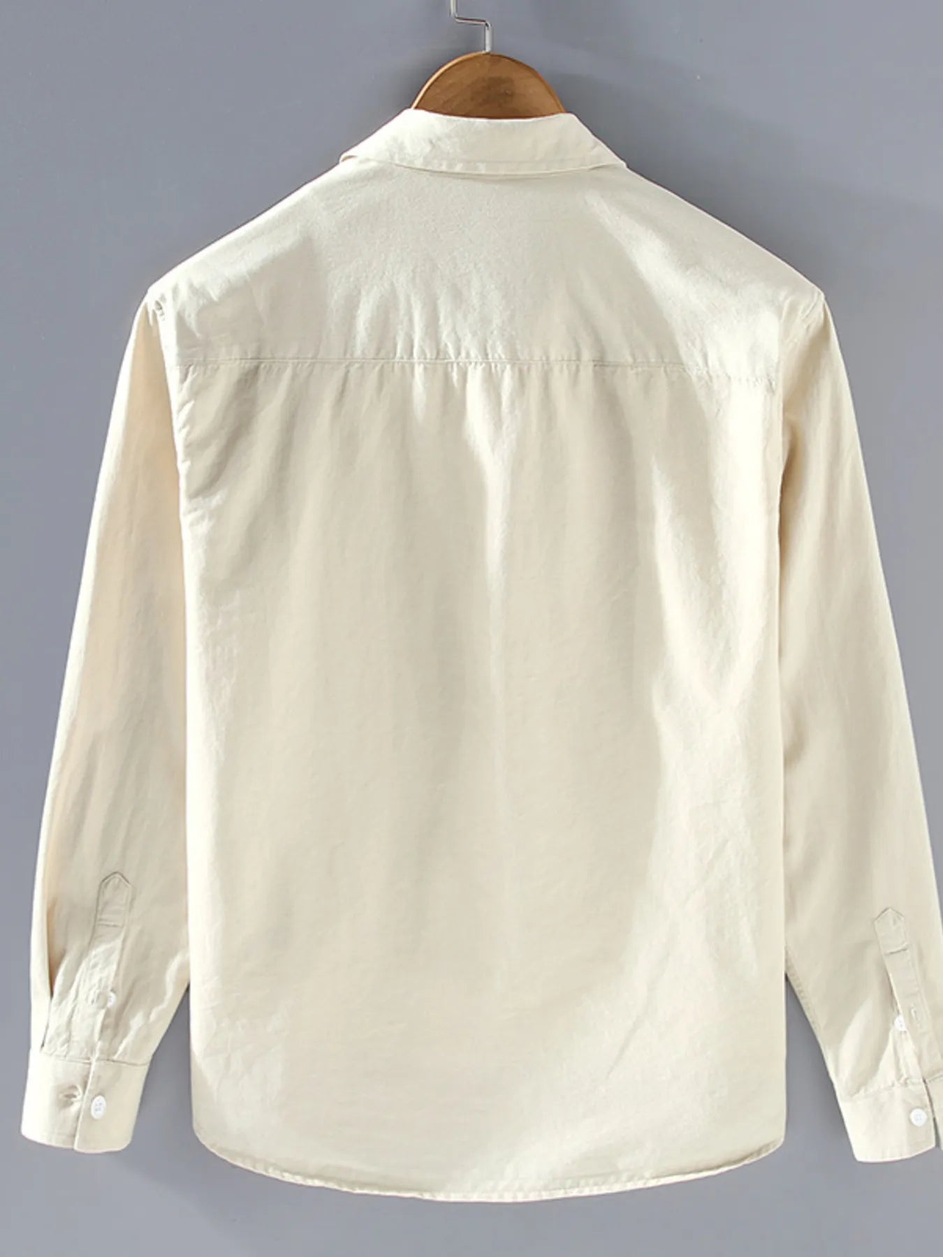 Light cream button-up long sleeve shirt with classic collar and buttoned cuffs.