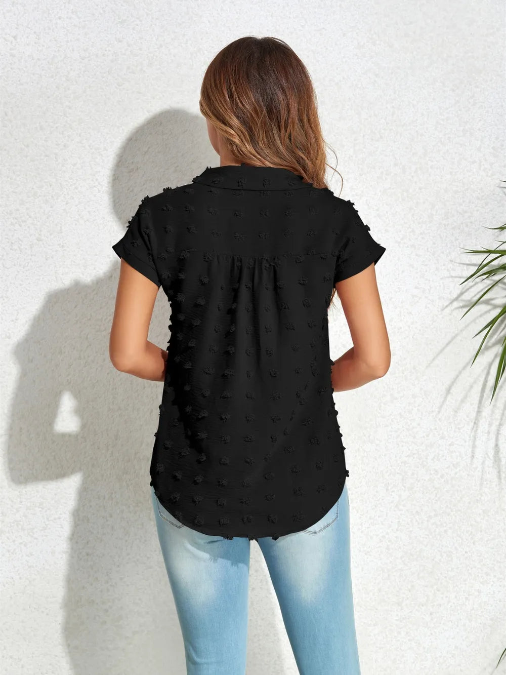 Black swiss-dot cap-sleeve shirt with back yoke pleats and rounded hem