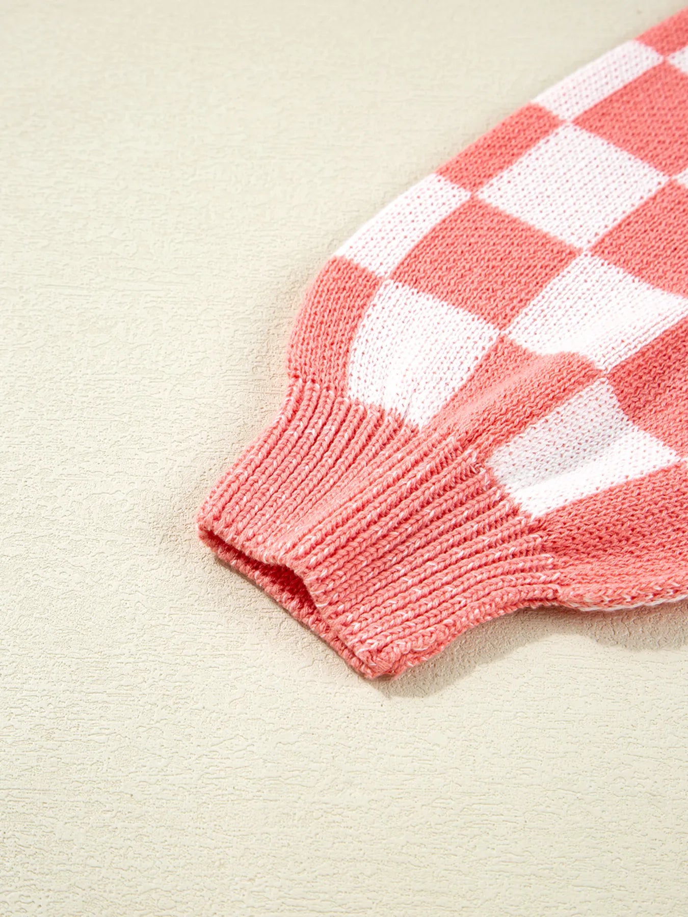 Burnt coral and white knit sweater sleeve end with ribbed cuff